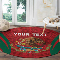 Round red rug with green aztec border, central eagle image and 'YOUR TEXT' print.