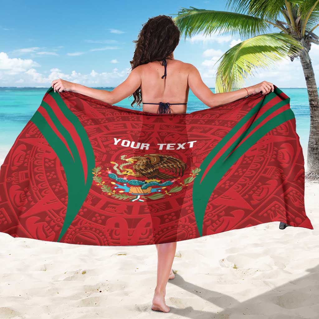 Red sarong with green border, aztec pattern and 'YOUR TEXT' on back, colorful emblem