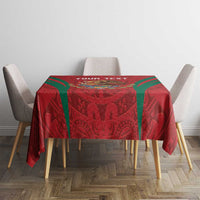 Red rectangular tablecloth with Aztec pattern and green stripe edging on dining set