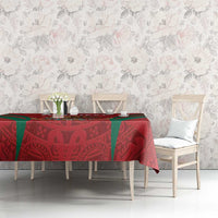 Red custom tablecloth with Aztec-style calendar pattern and green diagonal accents on table