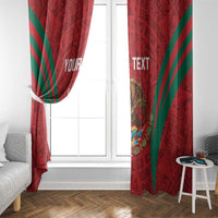 Red window curtain pair with green diagonal stripes and Aztec-style calendar artwork
