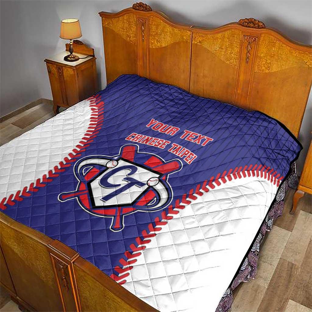 Blue and white baseball-style quilt with red trim and custom text, laid on a bed