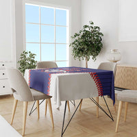 Blue baseball-style tablecloth draped on dining table with red/white stitched edge