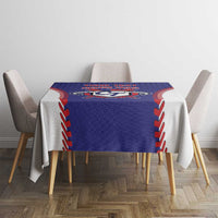 Blue tablecloth with red/white stitched border and central baseball-style emblem
