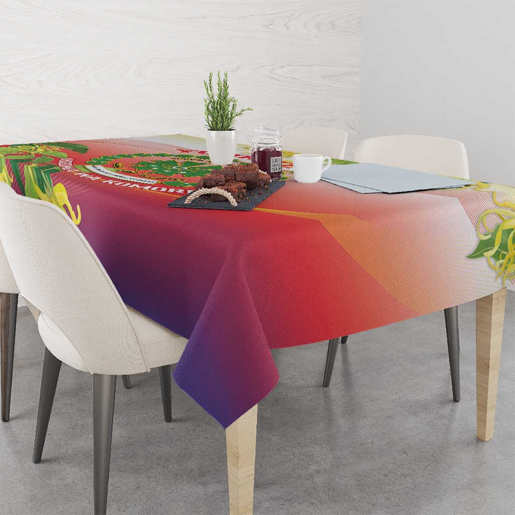 Red and purple tablecloth with green ylang ylang flower print covering a dining table