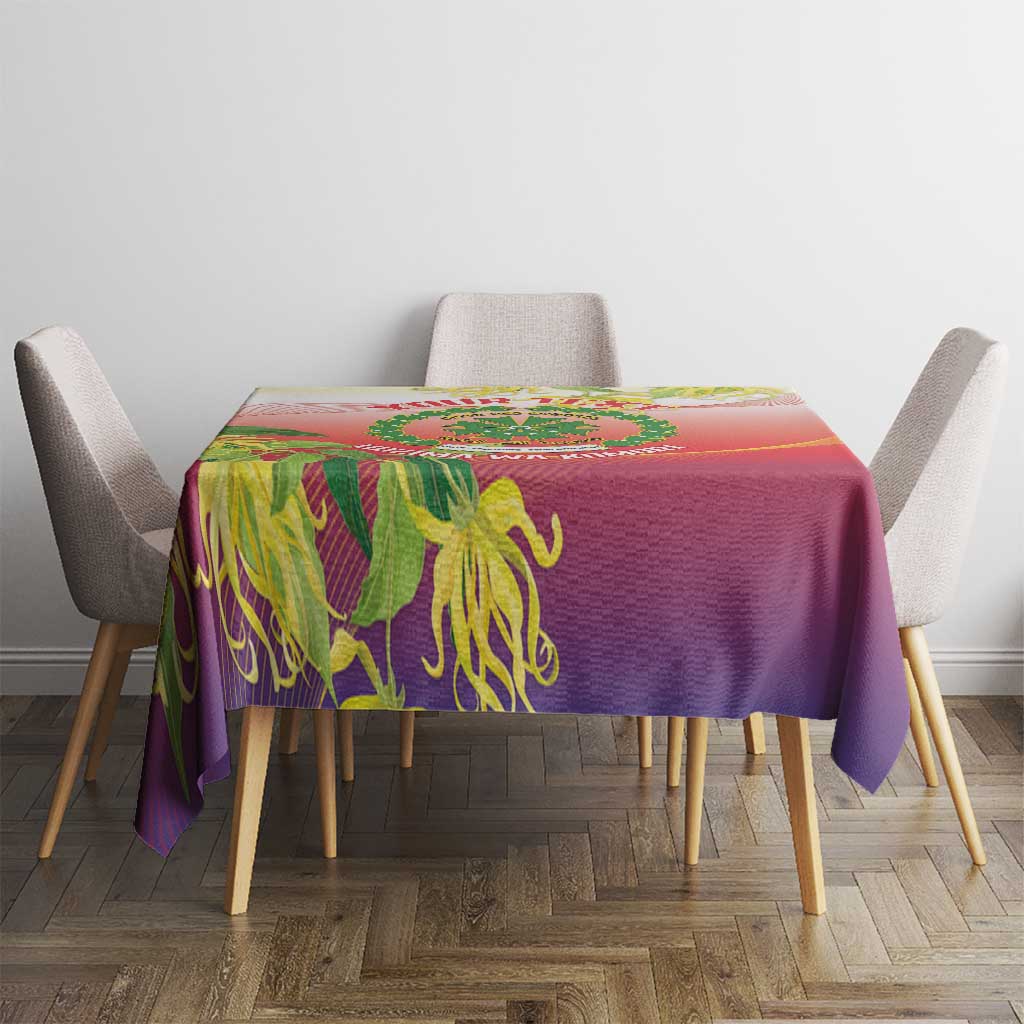 Red-purple tablecloth with green ylang ylang designs on the tabletop and draped edges