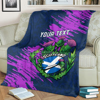 Navy rugby blanket on cream couch, purple brush design with YOUR TEXT and green Scotland thistle