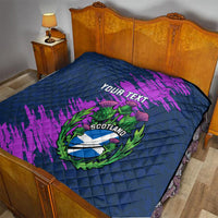Navy blue quilt blanket with purple brush strokes and Scotland thistle crest, “Your Text” on bed
