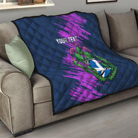Navy blue throw quilt with purple brush strokes and Scotland thistle crest, “Your Text” on sofa