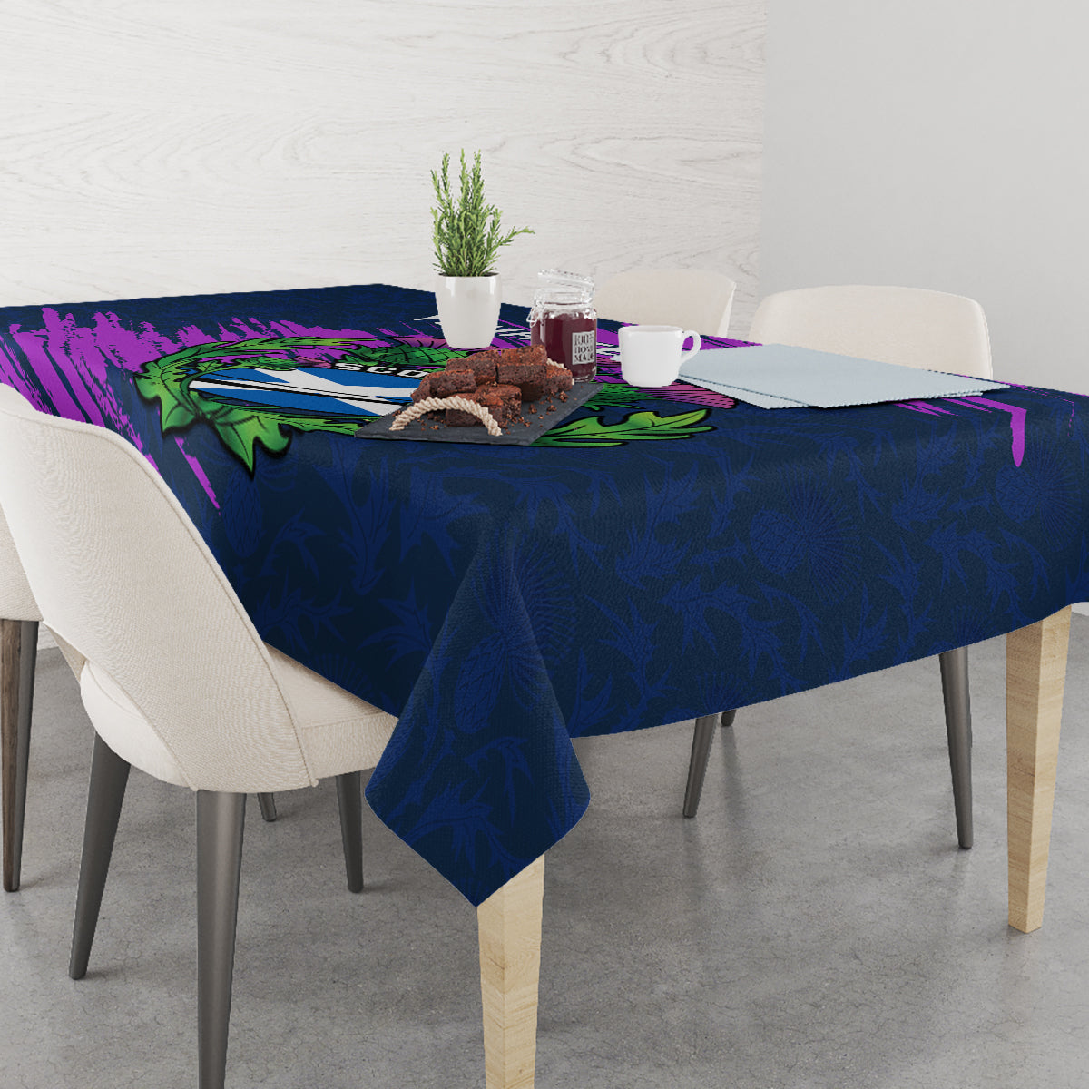 Navy blue tablecloth with purple Scotland thistle artwork and green leaf accents on table
