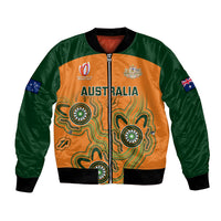 Unisex bomber jacket with green sleeves, orange Aboriginal-style front panels, zip closure
