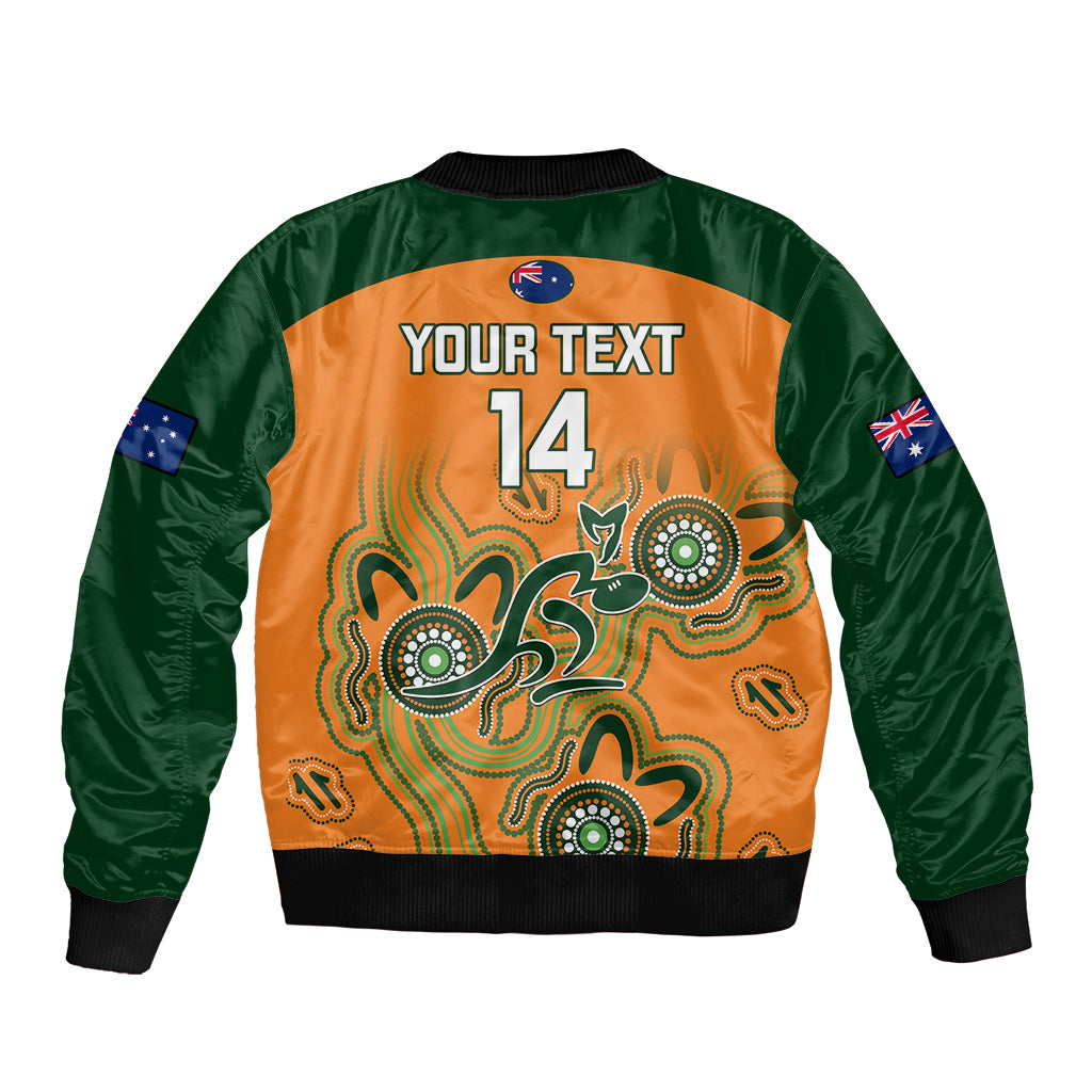 Personalized rugby bomber jacket back, green sleeves, orange Aboriginal design, 'YOUR TEXT 14'