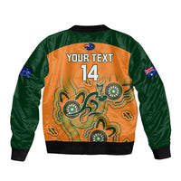 Personalized rugby bomber jacket back, green sleeves, orange Aboriginal design, 'YOUR TEXT 14'