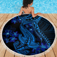 Blue round beach blanket with white fringe; tribal shark and floral pattern spread on deck