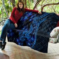 Blue Polynesian shark tattoo quilt with blue plumeria flowers, draped over couch cushions