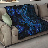 Blue shark tattoo quilt with blue plumeria flowers on a living room sofa