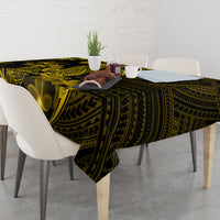 Dark tablecloth with gold Polynesian tribal design and plumeria flower motifs