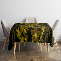 Dark tablecloth with gold plumeria flowers and geometric Polynesian tribal pattern
