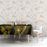 Dark tablecloth with gold plumeria flowers and tribal design on dining table