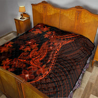 Quilt blanket on bed: black fabric with orange tribal shark tattoo and red flowers