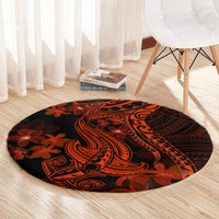 Round black rug with Polynesian shark tattoo and plumeria flowers in orange-red