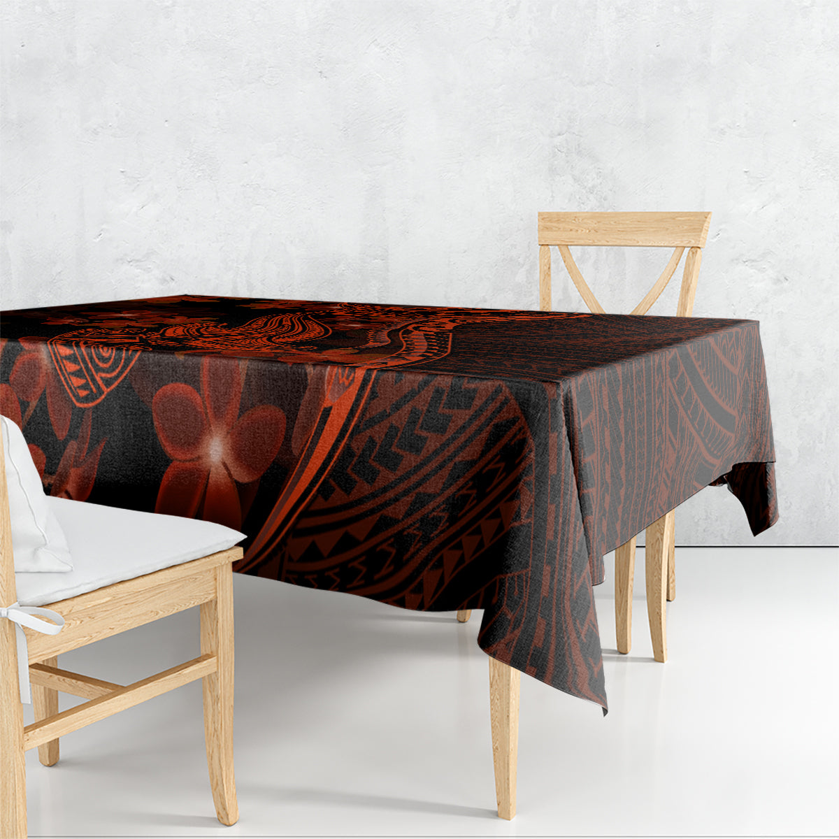 Polynesian tablecloth draped on dining table, dark black with red tribal shark and flowers