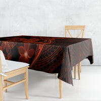 Polynesian tablecloth draped on dining table, dark black with red tribal shark and flowers