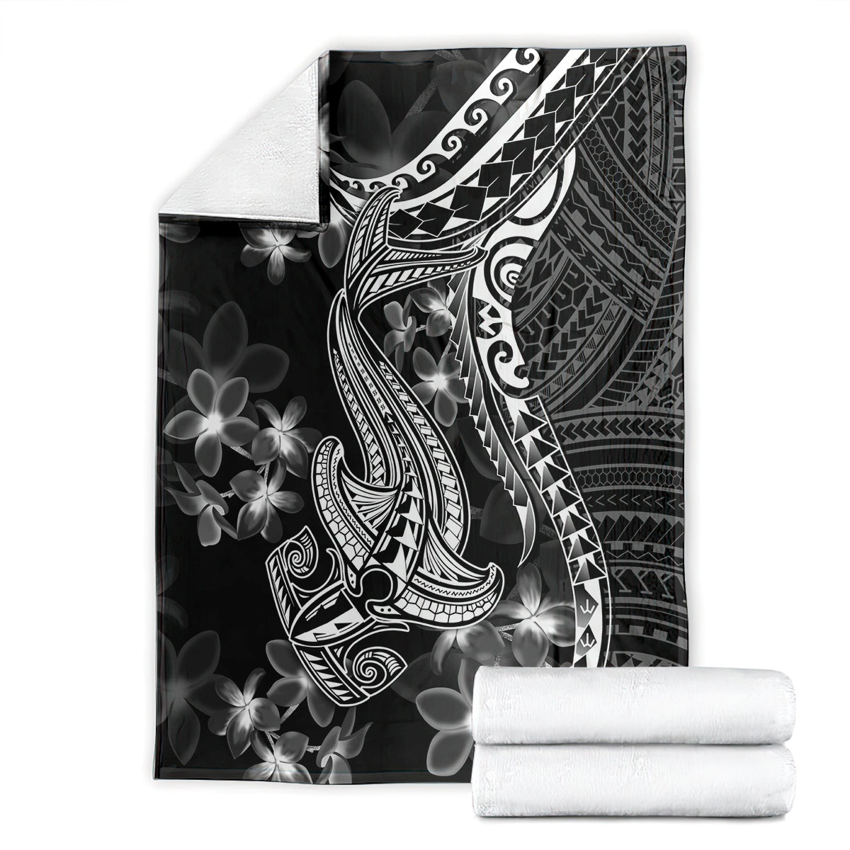 Black blanket folded in packaging with white shark tattoo and Polynesian plumeria design