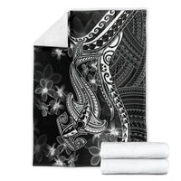 Black blanket folded in packaging with white shark tattoo and Polynesian plumeria design