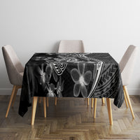 Black Polynesian tablecloth with large white flower, shark outline and tribal patterns