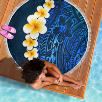 Round blue beach blanket with white fringe, tropical flowers and Polynesian motifs