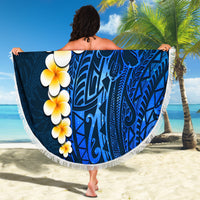 Round blue beach blanket with white fringe, flower garland and Polynesian pattern