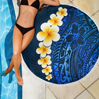 Round blue beach blanket with white fringe, tropical flowers over Polynesian motifs