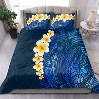 Blue bedding set with plumeria floral print, ornate tropical design across the duvet