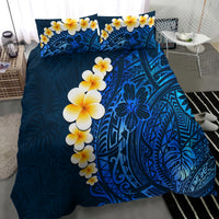 Blue duvet set featuring yellow-and-white plumeria blossoms over detailed tropical motifs