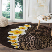 Round dark-brown rug with plumeria blossoms and Polynesian tribal swirl pattern