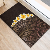 Brown rubber doormat with dark botanical print and white plumeria flowers near center