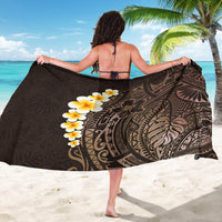 Brown polynesian sarong draped open with dark motif and yellow plumeria flowers