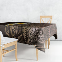 Brown Polynesian tablecloth with tropical leaf and geometric motif, draped over table.