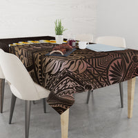 Brown tablecloth with Polynesian leaf and geometric design, topped with decor on table.