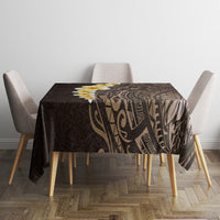 Brown rectangular tablecloth featuring Polynesian leaf and geometric pattern on tabletop.