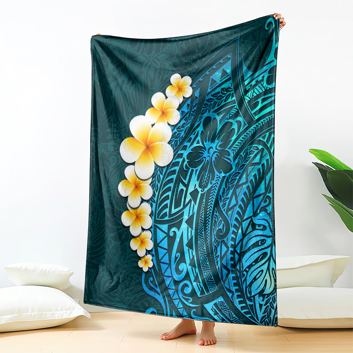 Turquoise tropical Polynesian blanket with plumeria flowers and leaf pattern, corner folded.