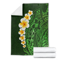 Green tropical plumeria blanket folded, showing leaf and geometric Polynesian pattern