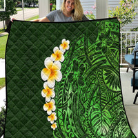 Green quilted blanket with green Polynesian-style leaf and flower pattern, yellow plumeria.