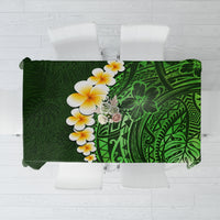 Green tropical tablecloth with plumeria flowers and patterned Polynesian leaf design