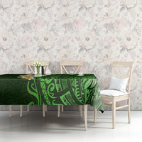 Green tropical tablecloth with plumeria and patterned Polynesian leaves on dining set