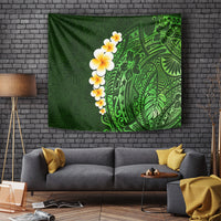 Green tropical tapestry with plumeria flowers and Polynesian leaf pattern