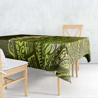 Lime green tablecloth with dark botanical and geometric Polynesian-style print, draped