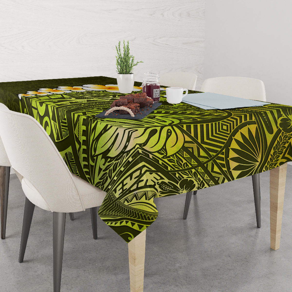 Lime green tablecloth with geometric Polynesian print and plumeria flowers on dining table