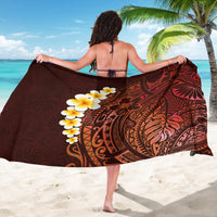 Red-brown sarong with bold black tribal print and yellow plumeria accents